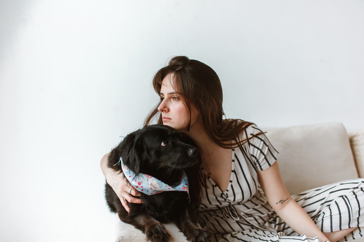 A woman sitting and hugging a dog — Photo from Pexels